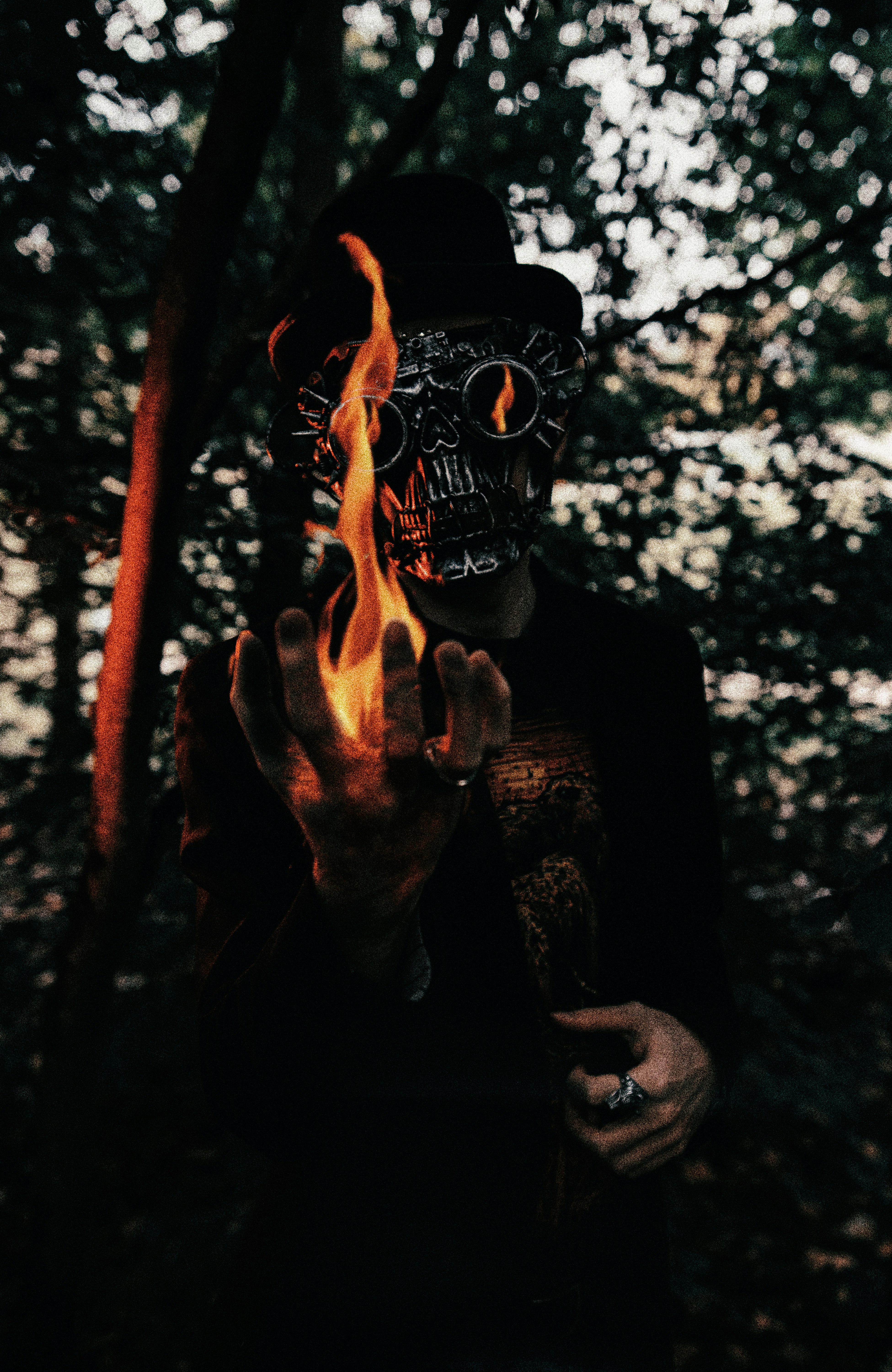 person in black mask holding fire
